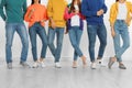 Group of young people in stylish jeans near wall, closeup Royalty Free Stock Photo