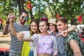 Group of young people at summer festival, taking selfie with smartphone. Royalty Free Stock Photo