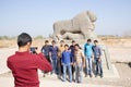 A group of young people taking a picture with the lion of Babylo