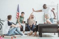 group of young people talking to each other and smiling african american man