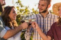 Group of young people tasting wine in winery near vineyard Royalty Free Stock Photo