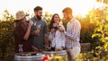 Group of young people tasting wine in winery near vineyard Royalty Free Stock Photo