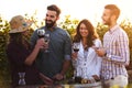 Group of young people tasting wine in winery near vineyard Royalty Free Stock Photo