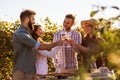 Group of young people tasting wine in winery near vineyard Royalty Free Stock Photo