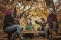 Group of young people throwing up leaves in a park. Happiness in