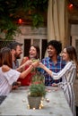 Group of young people toasting with drink Royalty Free Stock Photo