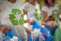 Group of young people volunteering, picking up trash. Cleaning nature from garbage. Environmentalism, green living, volonteering