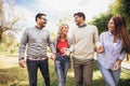 Young people walking through park. Friends having fun outdoor Royalty Free Stock Photo