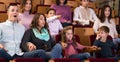 Group of people watching exciting movie