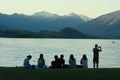 Group of young people watching sunset at lake Wanaka