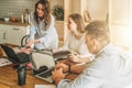 Group of young people working together.Man is using laptop,girls looking on screen of laptop,discussing business plan. Royalty Free Stock Photo