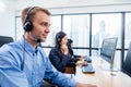 Group of young profession call center operator agent with headsets working in office. Business telemarketing service people Royalty Free Stock Photo