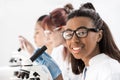 Group of young professional scientists working with microscopes in chemical lab Royalty Free Stock Photo