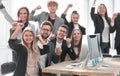 Group of young professionals sitting at an office Desk.