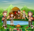 Group of young scout girls and boys are exploring in nature