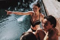 Group of Young Smiling Women Sitting at Poolside Royalty Free Stock Photo