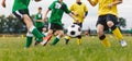 Group of Young Soccer Players Playing Football Game at Grass Venue. Happy School Boys Kicking Soccer Ball Royalty Free Stock Photo