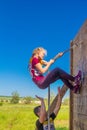 A group of young sport girl overcome the obstacles of the race of heroes competition. Text in Russian: Race of Heroes Royalty Free Stock Photo