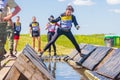 a group of young sport girl overcome the obstacles of the race of heroes competition. Text in Russian: Race of Heroes Royalty Free Stock Photo