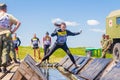 a group of young sport girl overcome the obstacles of the race of heroes competition. Text in Russian: Race of Heroes Royalty Free Stock Photo