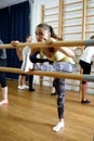 Group of young sports woman does an extension exercise