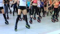 Group of young sporty women doing fitnes exercises with kangoo jumps shoes in a gym.