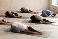 Group of women practicing yoga in Balasana pose