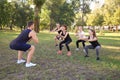 Group of young sporty people doing exercise outdoors Royalty Free Stock Photo