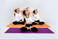 Group of young sporty people doing yoga , stretching exercise, working out, indoor close up Royalty Free Stock Photo