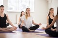 Group of young sporty people practicing yoga, doing Sukhasana ex Royalty Free Stock Photo