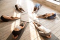 Group of young sporty people practicing yoga lesson, Balasana po