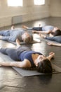 Group of young sporty people in Savasana exercise Royalty Free Stock Photo