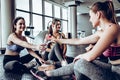 Group of young sporty smiling people sitting on the floor. Royalty Free Stock Photo