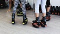 Group of young sporty women doing fitnes exercises with kangoo jumps shoes in a gym.