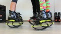 Group of young sporty women doing fitnes exercises with kangoo jumps shoes in a gym.