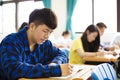 Group of young students writing notes in the classroom Royalty Free Stock Photo