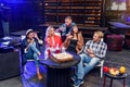 Group of young people sitting around and eating pizza. Friends partying and eating pizza. Royalty Free Stock Photo