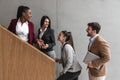 Group of young successful business people on stairs of office building happy with new ideas and satisfied with work support each Royalty Free Stock Photo