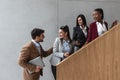 Group of young successful business people on stairs of office building happy with new ideas and satisfied with work support each Royalty Free Stock Photo