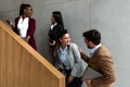 Group of young successful business people on stairs of office building happy with new ideas and satisfied with work support each