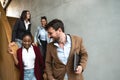 Group of young successful business people on stairs of office building happy with new ideas and satisfied with work support each Royalty Free Stock Photo