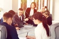 Group of young successful businessmen lawyers communicating together in a conference room while working on a project