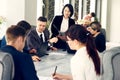 Group of young successful businessmen lawyers communicating together in a conference room while working on a project