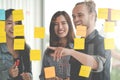 Group of young successful creative multiethnic team smile and brainstorm on project together in modern office with post note or st Royalty Free Stock Photo