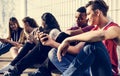 Group of young teenager friends chilling out together using smartphone social media concept Royalty Free Stock Photo