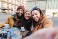 Group of young tourist people smiling and having fun taking a selfie portrait looking at camera. Front view of Royalty Free Stock Photo