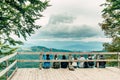 Group of young tourists sitting on a wooden bridge Royalty Free Stock Photo