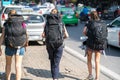 Group of young travelllers with heavy travel backpack walking on street of Hanoi city. Asia economy travel concept