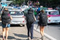 Group of young travelllers with heavy travel backpack walking on street of Hanoi city. Asia economy travel concept