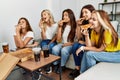 Group of young woman friends smiling happy eating pizza at home Royalty Free Stock Photo